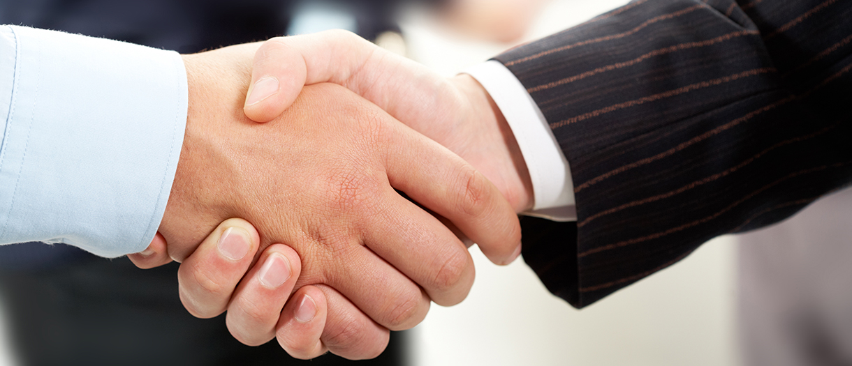 A business partnership beginning with a handshake